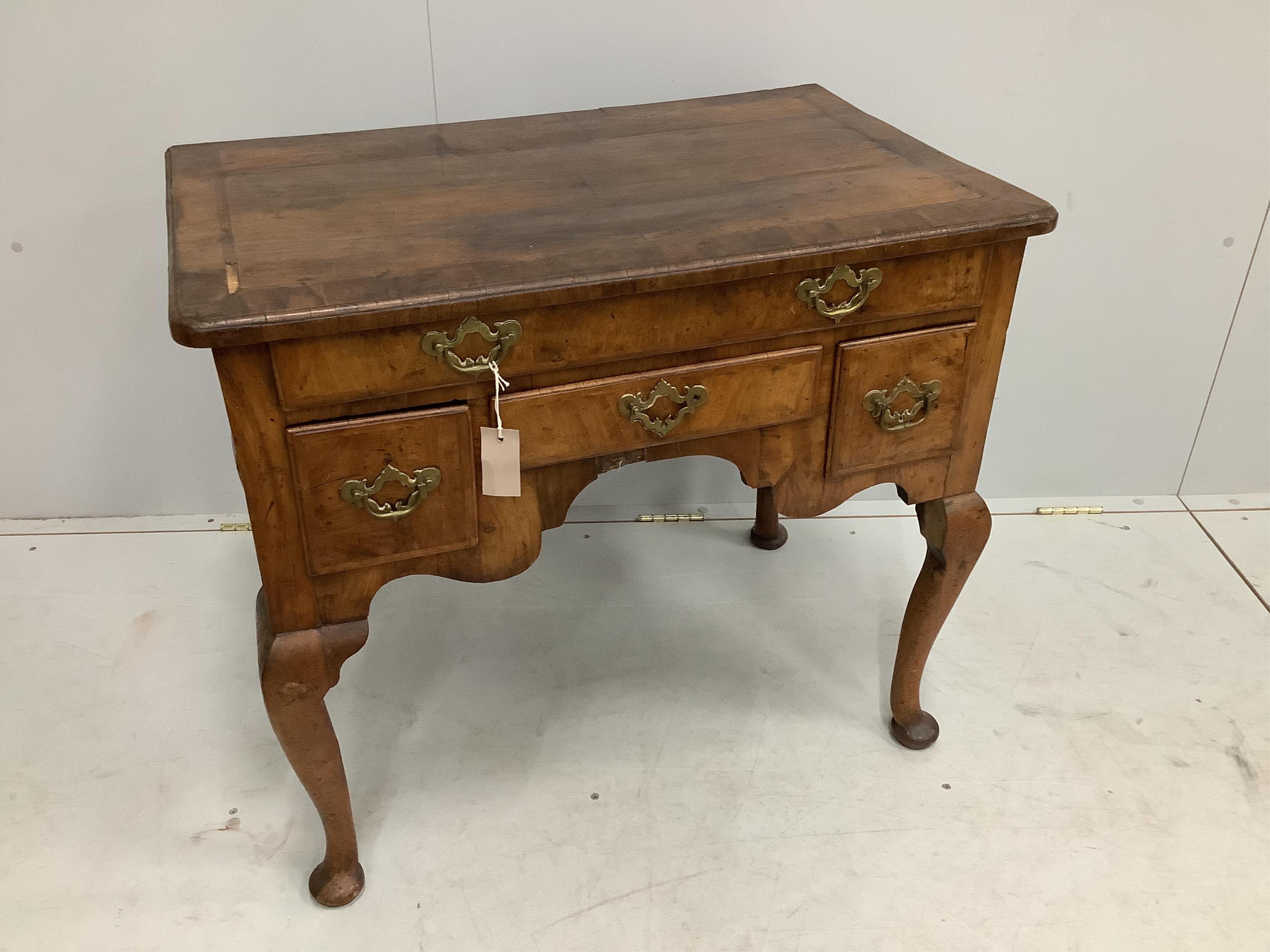 An 18th century feather banded walnut lowboy, width 81cm, depth 52cm, height 72cm